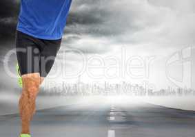 Male runner legs on road with skyline and storm