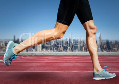 Runner legs on track against skyline