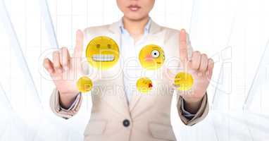 Business woman with emojis and flares between hands against white window