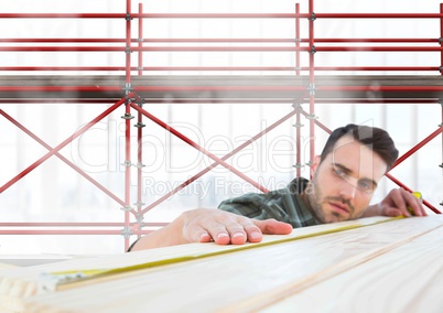 Builder measuring wood in front of 3D scaffolding