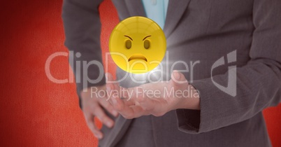 Close up of woman's hand with emoji and flare against red wall
