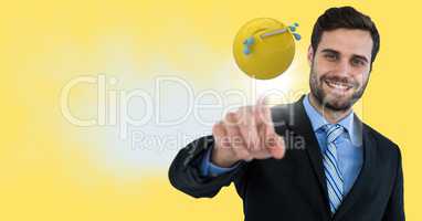 Business man touching emoji and flare against yellow background and cloud