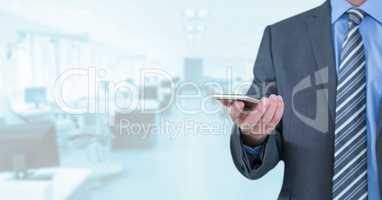 Businessman with phone in bright office