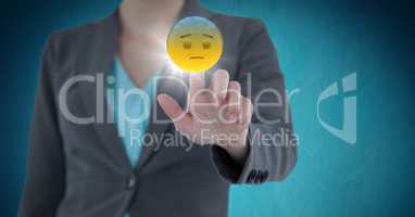 Business woman mid section touching emojis with flare against blue background