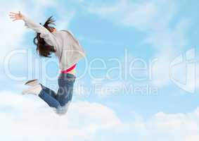 Woman jumping ecstatic in cloudy sky