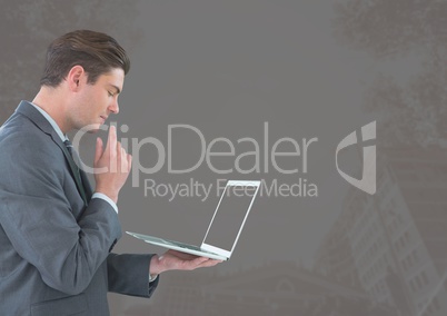 Businessman with tablet against grey background