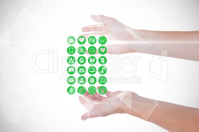 Digital composite image of hands with various medical icons