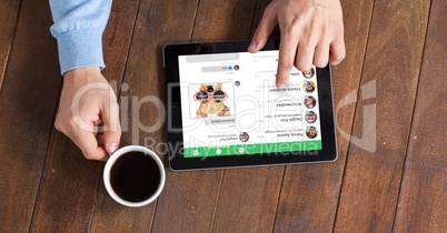 Hands using tablet PC while having coffee