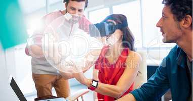 Businesswoman looking at globe through VR glasses by colleagues
