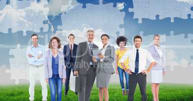 Digital composite image of business people standing against puzzle background