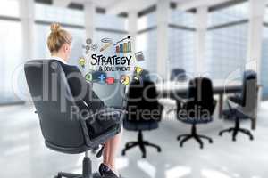 Businesswoman using laptop while strategy sign is surrounded by icons