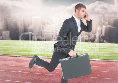 Business man on phone with briefcase and running on track against skyline with clouds