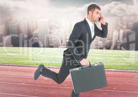 Business man on phone with briefcase and running on track against skyline with clouds