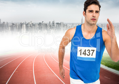 Male runner sprinting on track against blurry skyline