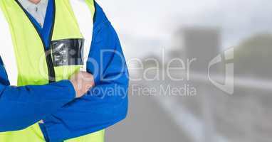 Builder with his hands folded on blurred background of the city