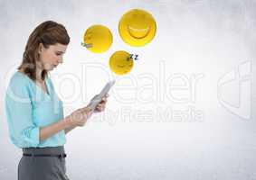 Woman with tablet and emojis with flare against white wall