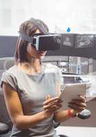 Woman with tablet wearing VR Virtual Reality Headset with Interface