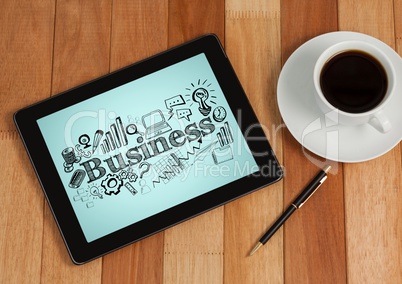 Tablet next to coffee showing black business doodles against blue background