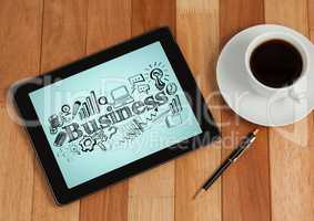 Tablet next to coffee showing black business doodles against blue background