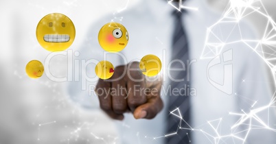 Business man mid section touching emojis with flare against blurry grey background