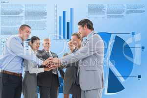 Business people stacking hands against graphs
