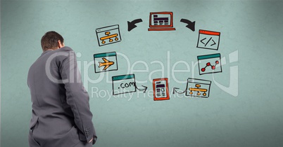 Rear view of businessman looking at diagram on wall