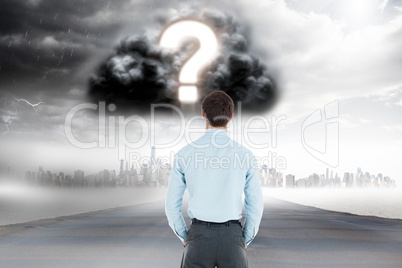 Digitally generated image of businessman looking at question mark in cloudy sky over city