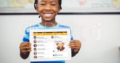 Happy boy showing tablet PC with social site displayed on screen