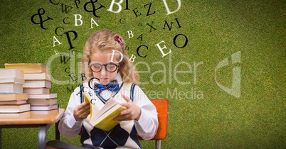 Female student reading book while letters flying in background