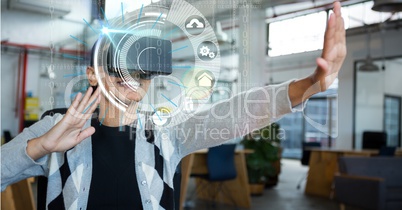 Digital composite image of woman using VR glasses in office