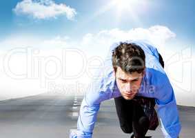 Business man in blue on road against sky with sun