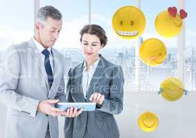 Business people with tablet against window and emojis