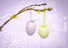 Easter eggs hanging on branch in front of pattern
