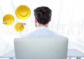 Back of man sitting with emojis against white window