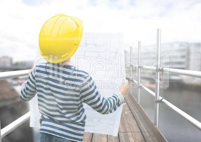 Boy looking blueprint in 3D scaffolding
