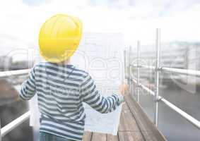 Boy looking blueprint in 3D scaffolding