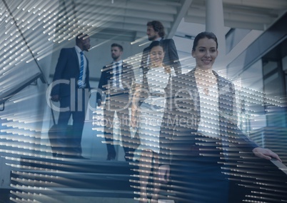 Business people walking down stairs with map graphic overlay