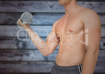 Man mid section weightlifting against blurry blue wood panel