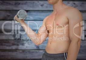 Man mid section weightlifting against blurry blue wood panel