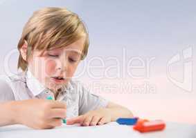 Young boy coloring with soft bright background