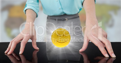 Close up of business woman's hands on table with emojis and flare against blurry map