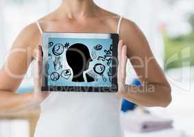 Woman holding tablet showing head doodle and blue background