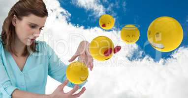 Digital composite of businesswoman with emojis against cloudy sky