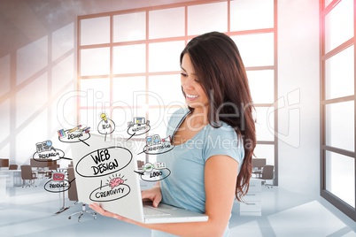 Smiling businesswoman web designing on laptop in office