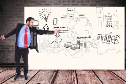 Businessman gesturing over graphs and diagrams on billboard against wall