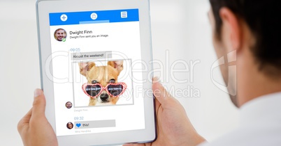Cropped image of person using digital tablet for text messaging against white background