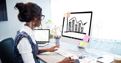 Businesswoman analyzing graph on desktop computer