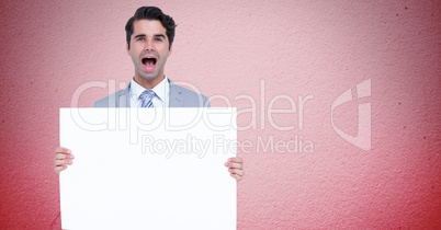 Portrait of businessman shouting while holding blank billboard against pink background