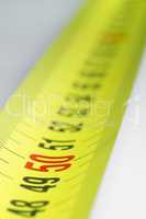 Yellow metal industrial tape measure.