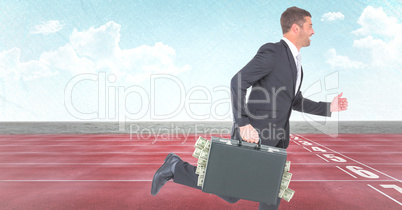 Business man with money sticking out of briefcase on track against sky